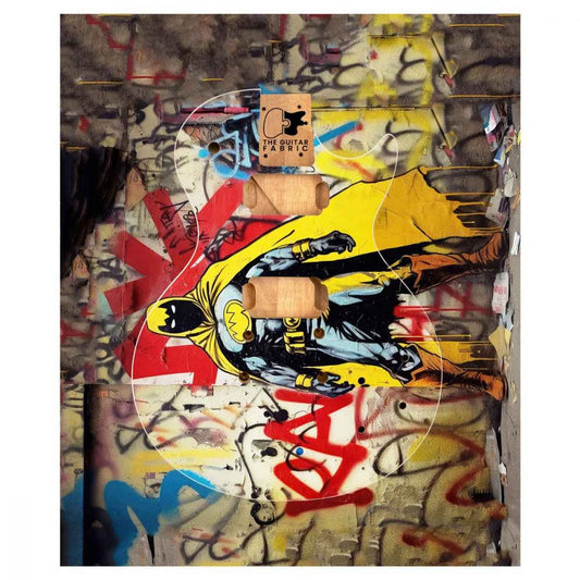 Super Hero Graffiti Guitar Skin flat lay showing bold yellow and red comic-style artwork with street art background texture.