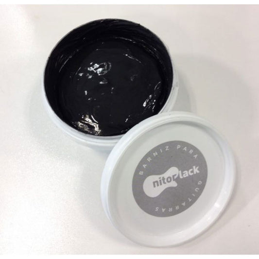 Grain Filler Waterbased Black in white container, lid open showing dense black paste inside
