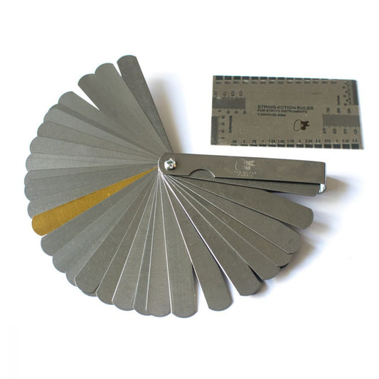 String action gauge and feeler blade kit with 32 precision blades fanned open, plus ruler tool displayed overhead.
