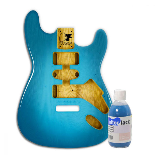 Aquamarine water-based dye bottle displayed next to finished guitar body stained in bright blue