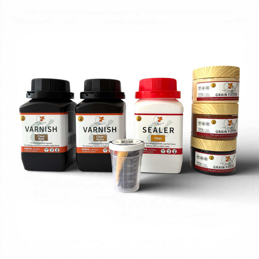 Custom Guitar Finish Bundle components displayed flat: clear varnish bottles, sealer, grain filler rolls, and mixing cup
