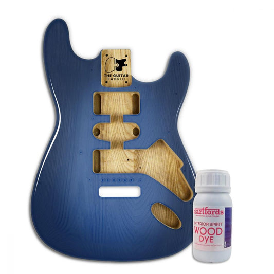 Blue alcohol-based dye bottle shown next to blue guitar body with wooden pickguard and hardware