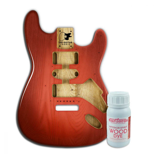 Red Tomato alcohol-based wood dye bottle displayed next to finished guitar body showing transparent red finish