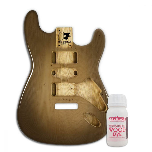 Teak alcohol-based wood dye bottle displayed next to finished guitar body showing warm brown tone on wood