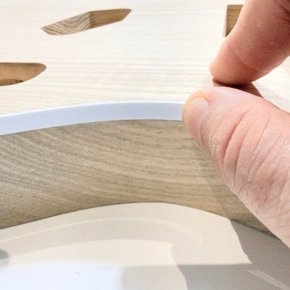 White binding pressed into the edge of the guitar body