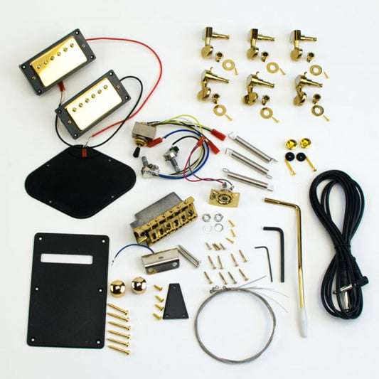 Complete PRS guitar parts set with gold hardware, pickups, wiring, tremolo bridge, machine heads, and black covers laid flat