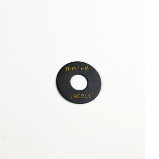 Black Rhythm Treble plate with gold lettering, top-down view showing center hole for LP style guitar.