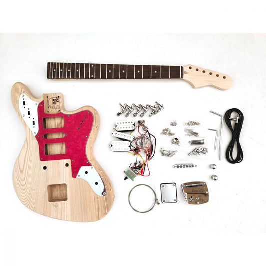 DIY Guitar Kit Jaguar Cobain flat lay with unfinished ash body, maple neck, pickguard, electronics, and hardware