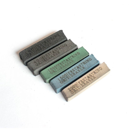 Five sanding fret erasers in graduated grits 180 to 2000 arranged in diagonal row showing color-coded blocks