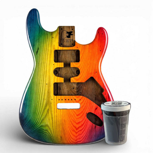 Rainbow-dyed electric guitar body next to 50 ml mixing container, showing transparent dye application results.