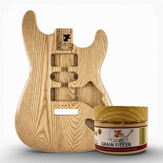 Stainable Natural Ash Grain Filler 200g jar displayed next to ash guitar body showing open pores