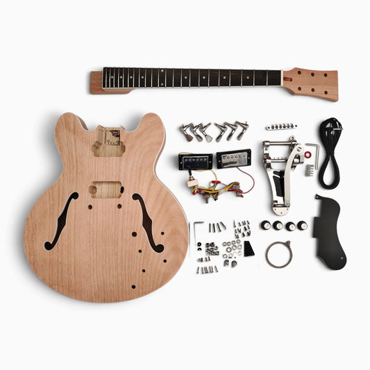 Semi hollow kit in mahogany with chrome vibrato tailpiece laid flat: unfinished body, neck, humbuckers, solderless wiring and hardware