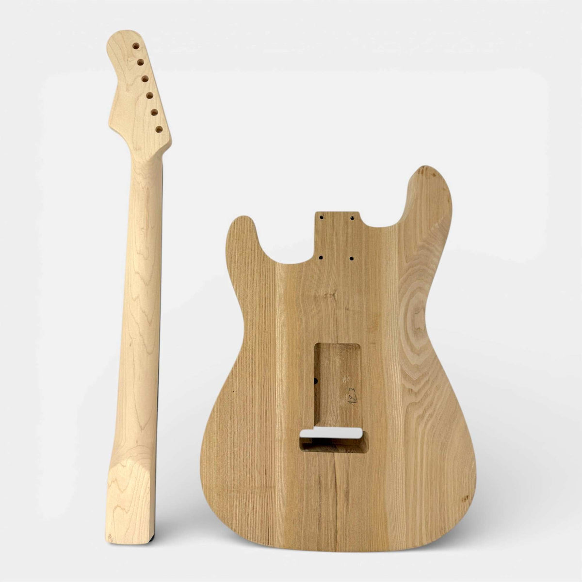 Maple neck and unfinished ash body of the ST-style kit