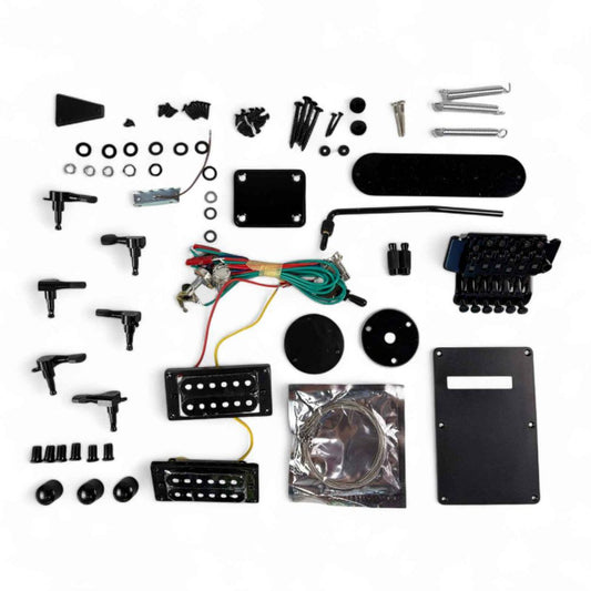 Black Razor full parts set flat lay showing humbuckers, Floyd tremolo bridge, tuners, electronics, and hardware from above