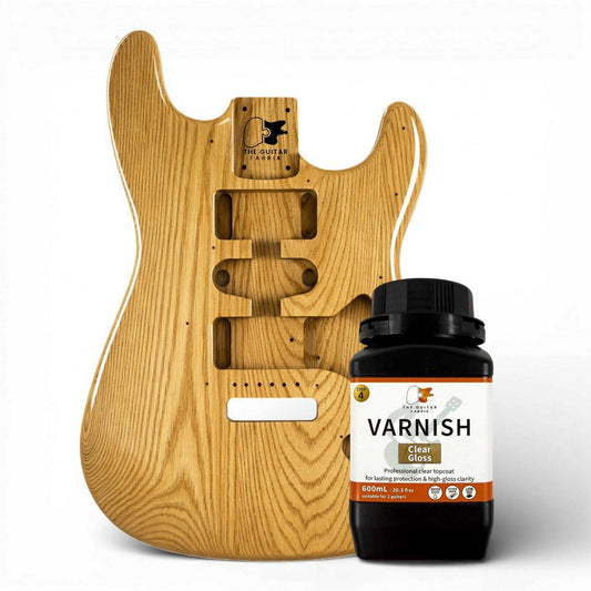 Water-based clear gloss lacquer 600mL bottle displayed next to wooden guitar body showing wood grain