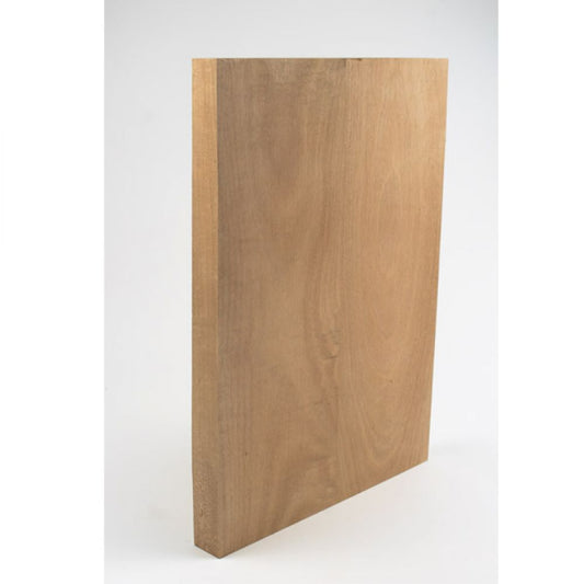 Mahogany wood block for guitar body shown from angled side view highlighting thickness and grain